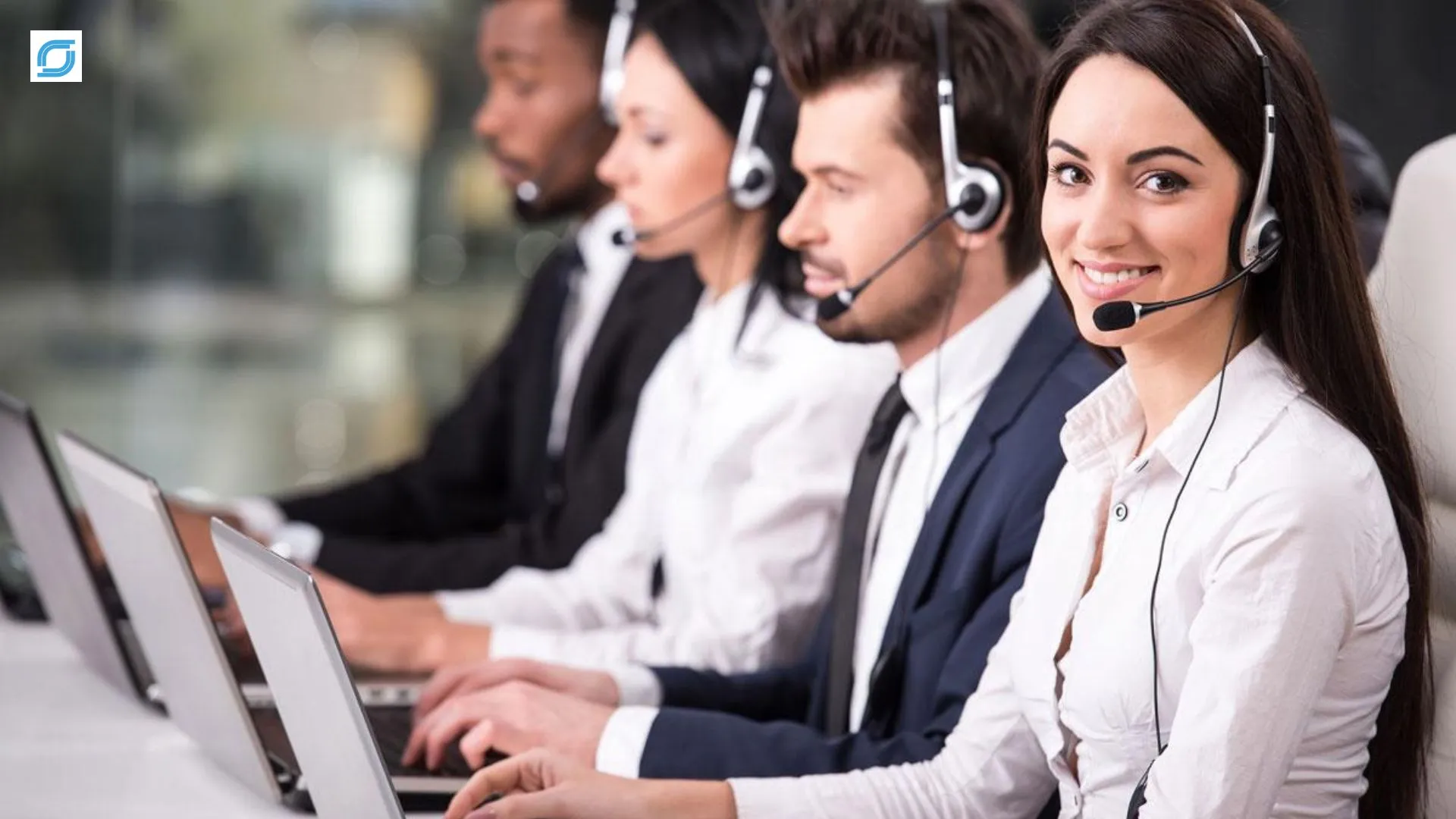 Telecom customer care team providing support through laptops and headsets