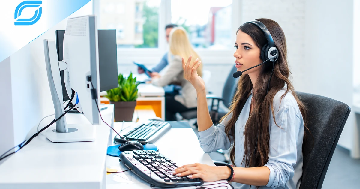 Telecom call center agent wearing a headset and managing customer conversations at her workstation.