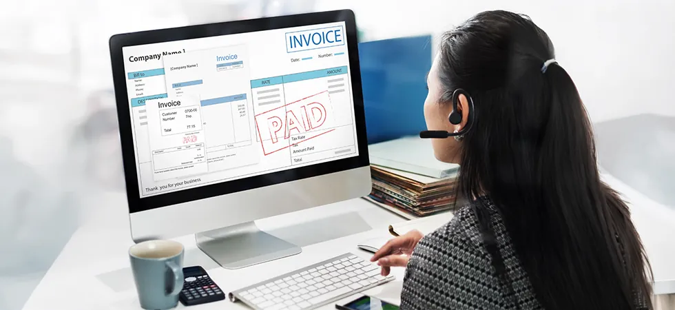 Billing dispute resolution agent reviewing complex broadband invoices on screen with headset