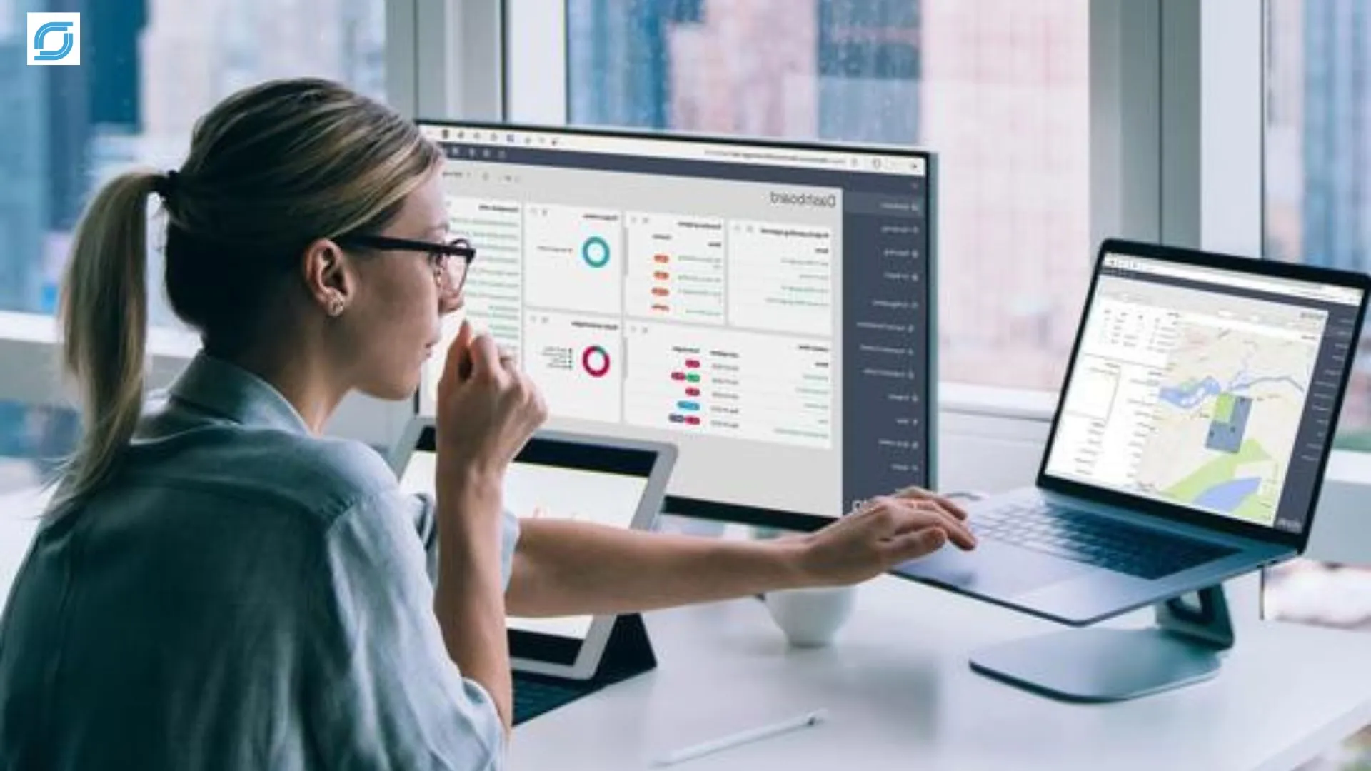 Telecom order management specialist monitoring order processing and provisioning dashboards on dual-screen workstation