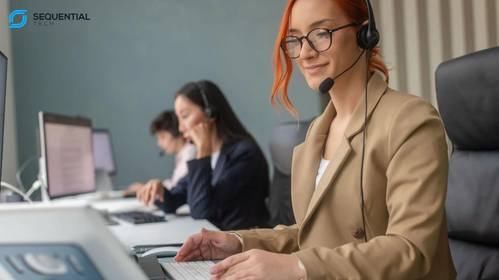 Telecom technical support agent resolving customer issue in a call center environment with headset and dual screens