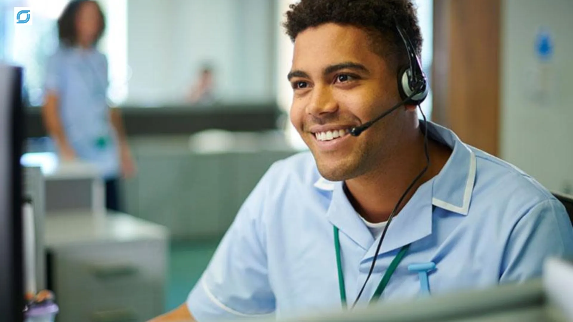 Telecom help desk support agent assisting a customer with headset in a modern contact center